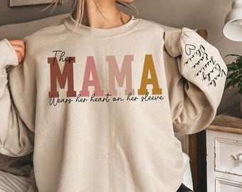 Custom This Mama Wears Her Heart On Her Sleeve Hoodie, Personalized Mom Sweatshirt With Kids Names, Cute Momma Outfit, Mothers Day Gifts