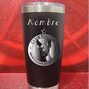 May include: Black stainless steel tumbler with a black and white logo of a dog breed with the text "Club Tijuana Xoloitzcuintles de Caliente" and the word "Nombre" above the logo.
