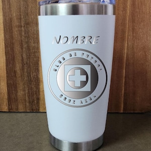 May include: White stainless steel tumbler with a silver logo that says "Club de Futbol Cruz Azul" and the word "NOMBRE" at the top.