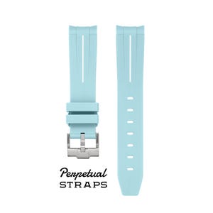 May include: Two light blue watch straps with a silver buckle. The straps have vertical lines and a series of holes. The text "Perpetual STRAPS" is printed below the straps.