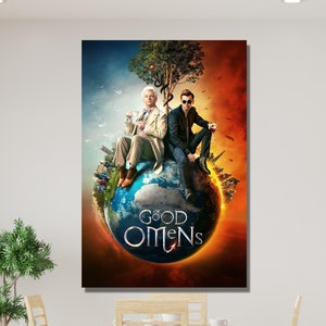 May include: A framed print of the "Good Omens" artwork. The image shows two figures seated on a globe, with a tree above them. The background is split between a blue sky and a fiery orange. The title "Good Omens" is displayed on the globe.