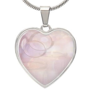 May include: A silver heart-shaped pendant necklace with a pink iridescent shell inlay. The pendant is on a silver chain.