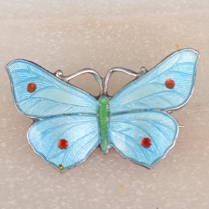 A silver and blue enamel butterfly brooch