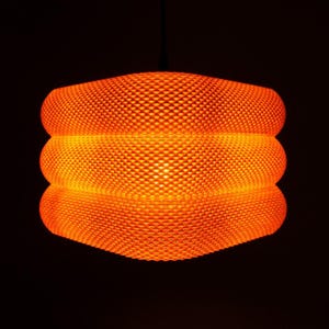 Edge-on view of illuminated lampshade (Mandarin) in dark room