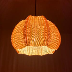 Lampshade (in Cotton colour) with light on in a dark room.