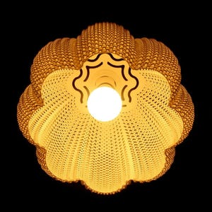 Bottom-up view of the lampshade with the light on (shown in Cotton colour).