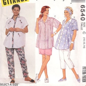 May include: A sewing pattern for a women's shirt and pants. The pattern includes three different styles of shirts: a white shirt with a floral print, a pink and white striped shirt, and a blue shirt with white polka dots. The pattern also includes a pair of pants with a floral print. The pattern is for sizes 10, 12, and 14.