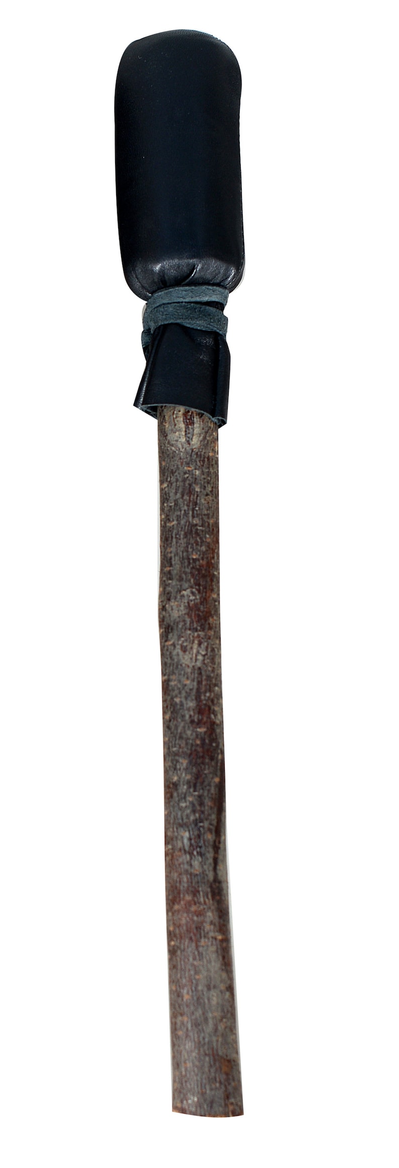 May include: A wooden stick with a black leather covering on the top. The leather is tied with a black string.