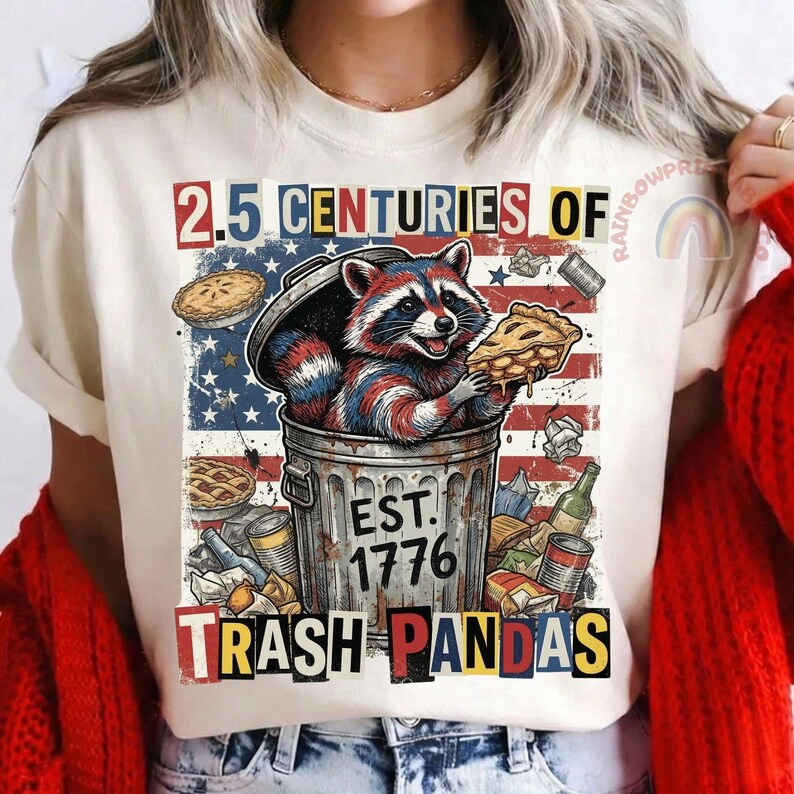 May include: A white ceramic mug with a black handle and the text "But First, Coffee" in a bold, black font. The mug is set against a blurred background, suggesting a cozy setting.