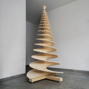 May include: A wooden Christmas tree made of stacked, spiraling slats. The tree is decorated with a star on top and stands on a wooden base.