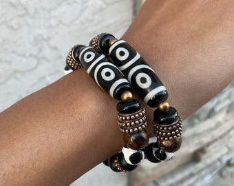 Handmade. DZI agate focal bead, bronzite, copper, and matte onyx make up this gorgeous culturally inspired bracelet.