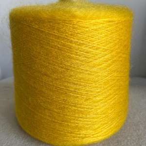 May include: A spool of bright yellow yarn with a fuzzy texture.