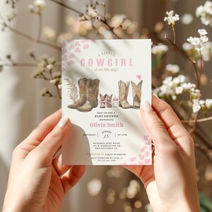 May include: A pink and white baby shower invitation with a watercolor illustration of cowboy boots and the text "A Little Cowgirl is on her way!"  Join us for a baby shower honoring Olivia Smith on Saturday, August 25 at 4 PM. Hundreds Acre Wood, 100 Washington St, Philadelphia, PA.