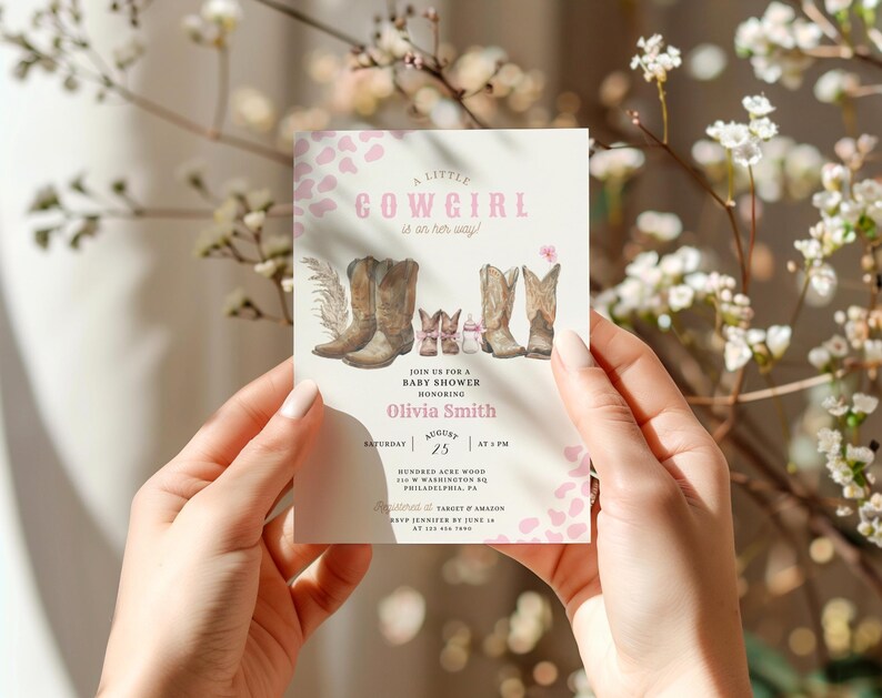 May include: A pink and white baby shower invitation with a watercolor illustration of cowboy boots and the text "A Little Cowgirl is on her way!"  Join us for a baby shower honoring Olivia Smith on Saturday, August 25 at 4 PM. Hundreds Acre Wood, 100 Washington St, Philadelphia, PA.