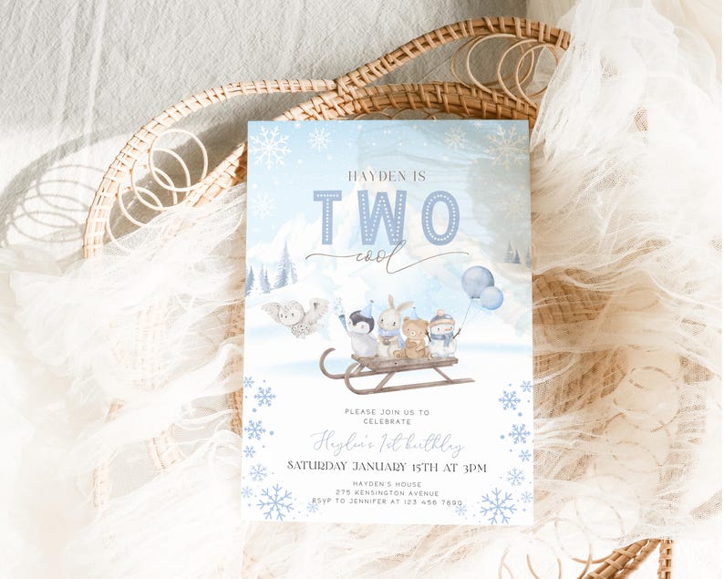 May include: A light blue birthday invitation with a winter theme. The text reads "Hayden is Two Cool". The invitation features illustrations of animals on a sled, snowflakes, and mountains. The party details are also included.