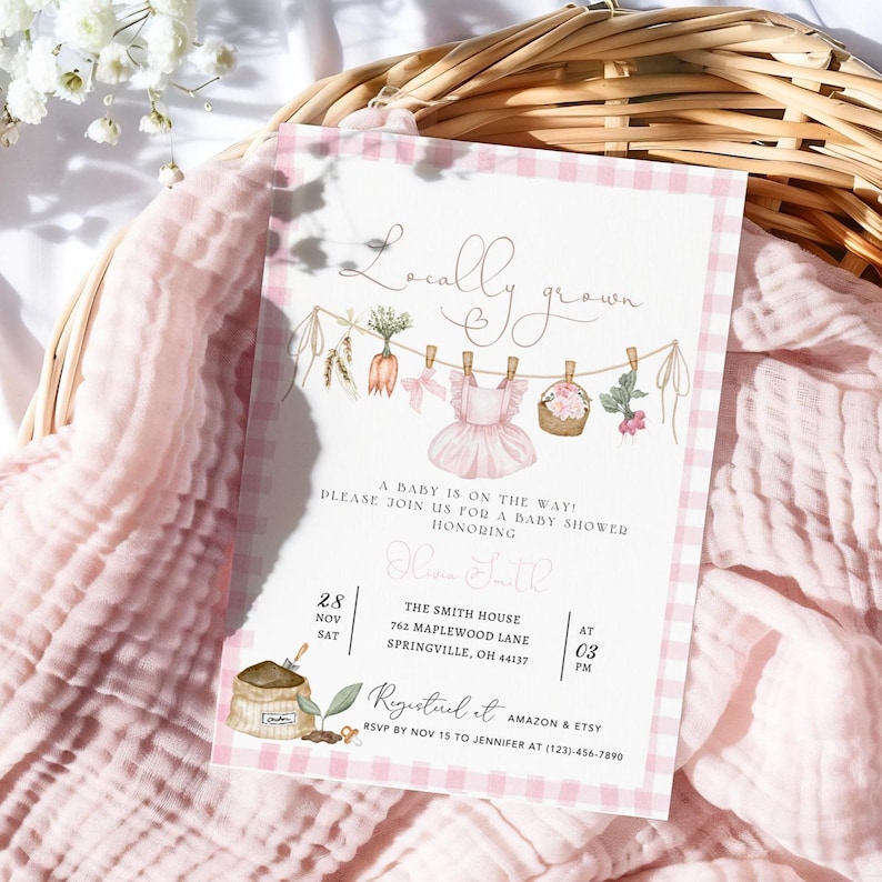 May include: A baby shower invitation with a pink gingham border and the words "Locally Grown." The invitation features illustrations of baby clothes, carrots, and flowers. The text reads "A baby is on the way!" and includes event details.