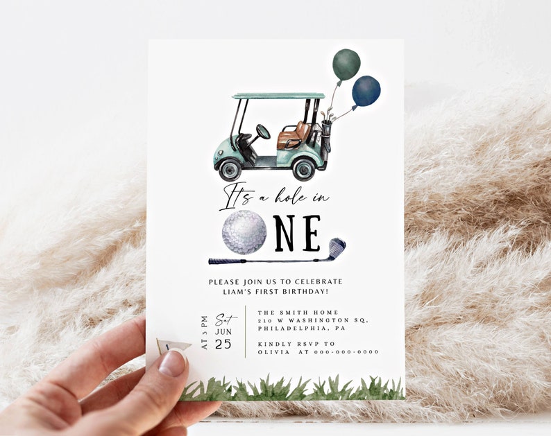 May include: A golf-themed first birthday invitation featuring a green and white golf cart, a golf ball, and a golf club. The invitation reads "It's a hole in one" and includes the date, time, and location of the party.