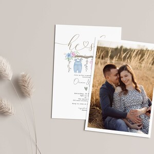 May include: A baby shower invitation with a watercolor illustration of a branch with two baby onesies hanging from it. The text on the invitation reads "He or She?" and includes the date, time, and location of the shower. A photo of a pregnant couple is included in the background.