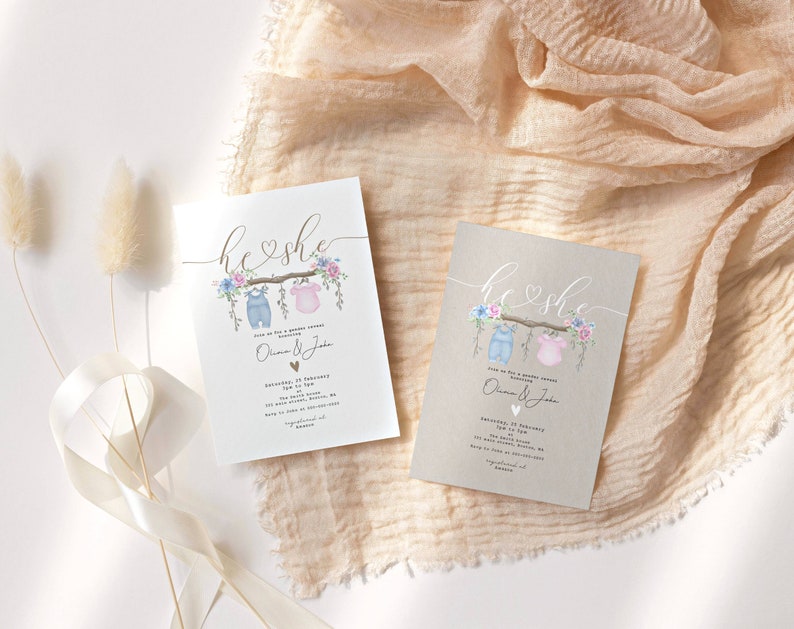 May include: Two gender reveal party invitations with a rustic brown background. The invitations feature a watercolor illustration of a clothesline with a blue baby outfit and a pink baby outfit hanging on it. The text "he & she" is written in cursive above the clothesline. The invitations also include the text "Join us for a gender reveal party" and the names "Olivia & Jake".