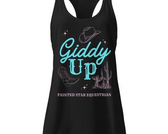 May include: Black tank top with a racerback design. The front features the words "Giddy Up" in turquoise script, along with illustrations of a cowboy hat, boots, and cactus. The text "Painted Star Equestrian" is below.