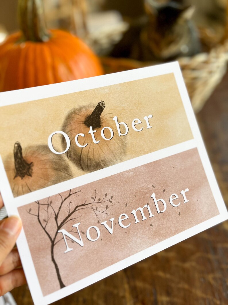 May include: Two printable cards with a fall theme. The top card is beige with a drawing of two pumpkins and the text "October". The bottom card is brown with a drawing of a bare tree and the text "November".