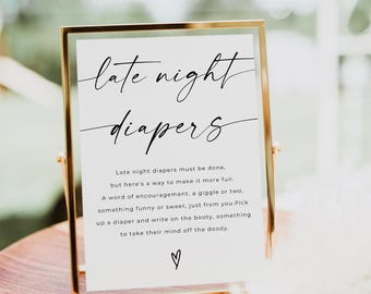 May include: A gold-framed sign with the text "late night diapers" in black cursive font. The sign has instructions for guests to write encouraging messages on diapers for the new baby.
