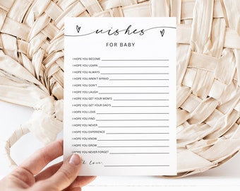 Può includere: Una carta di gioco per baby shower stampabile con il testo "wishes for baby" e un elenco di suggerimenti per gli ospiti per scrivere gli auguri per il nuovo bambino.