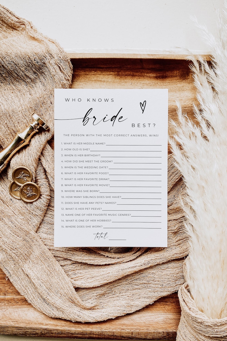 May include: A white ceramic mug with a black handle and the text "But First, Coffee" in a handwritten style. The mug is on a white surface. The mug is approximately 4 inches tall.