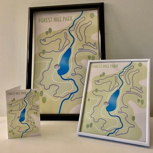 May include: Three framed maps of Forest Hill Park, each with a different scale. The maps are printed on a light green background with a blue river winding through the park. The maps are framed in black, white, and brown.