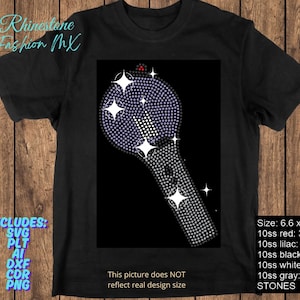 May include: Black t-shirt featuring a rhinestone design of a microphone-shaped object with a black background. The design includes white star accents and a red accent at the top. The shirt includes the text "Rhinestone Fashion MX".