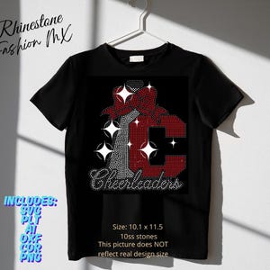 May include: Black t-shirt with a rhinestone design featuring a red bow and the letter "C" in red rhinestones. The word "Cheerleaders" is written in rhinestones below the letter. The shirt includes the text "Rhinestone Fashion MX".