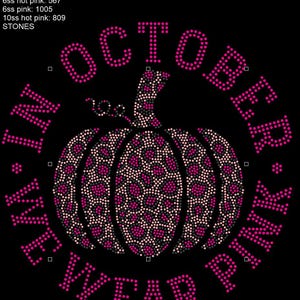 May include: A black background with a pink and white pumpkin with a leopard print design. The words "In October - We Wear Pink" are in a circle around the pumpkin.
