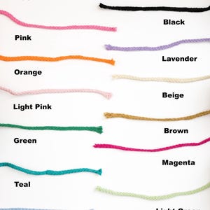 May include: A collection of colorful rope samples in various hues, including yellow, blue, pink, orange, light pink, green, teal, light blue, coffee, red, black, lavender, beige, brown, magenta, light green, and gold. Each rope is labeled with its color name.