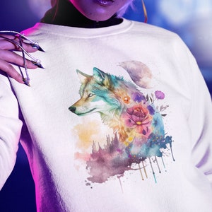 May include: White sweatshirt with a watercolor design of a wolf's head surrounded by flowers and a crescent moon.