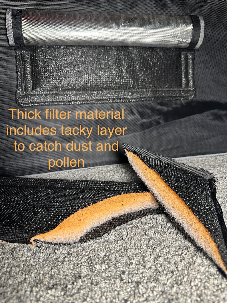 May include: Close-up of a black filter material with a brown sticky layer. The text "Thick filter material includes tacky layer to catch dust and pollen" is visible in the image.