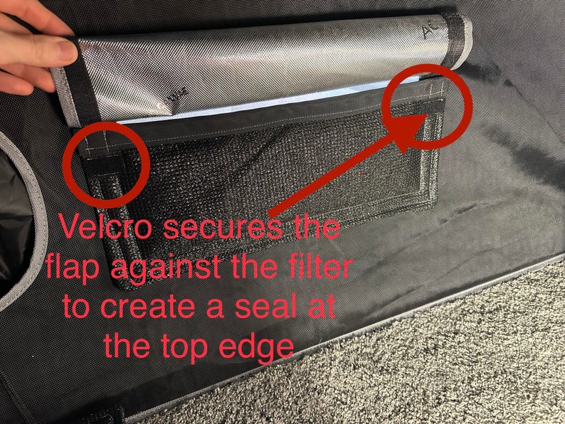 May include: A black fabric filter with a gray flap that secures with velcro. The flap has a mesh pocket and a silver lining. The text "Velcro secures the flap against the filter to create a seal at the top edge" is written below the filter.