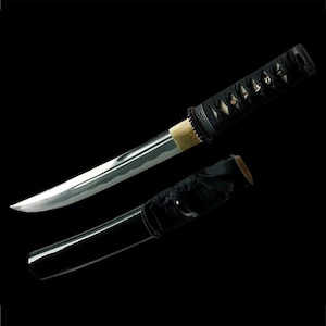 May include: A black and silver Japanese sword with a black handle and a black scabbard.