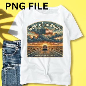 May include: White t-shirt with a graphic featuring a road leading to a sunset, an American flag, and the text "west of nowhere" and "made for open country". The shirt is paired with blue jeans.