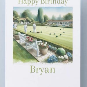 May include: A birthday card featuring a watercolour illustration of a lawn bowls scene. The words "Happy Birthday" and the name "Bryan" are printed in green. The scene includes a green lawn, players, and a white bench with flowers.