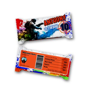 May include: A candy bar wrapper with the text "ANTHONY IS TURNING 10" and a graphic of a soldier. The wrapper has a colorful splatter design. The bottom wrapper shows nutrition facts and a barcode.