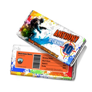 May include: A colorful chocolate bar wrapper with a paintball player design. The wrapper says "Anthony is turning 10" and "Thank you for celebrating with me". The back of the wrapper has a nutrition facts label with a fun graphic of a scuba mask.