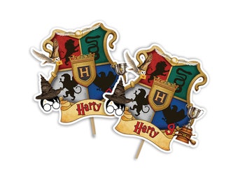 Op de afbeelding: Twee Harry Potter-thema caketoppers met een wapenschild met een leeuw, slang, adelaar en das. Het wapenschild wordt omringd door een banner met de tekst "Harry".