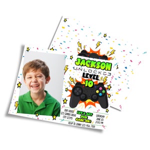 May include: A birthday party invitation featuring a photo of a smiling child. The invitation has a white background with a black game controller graphic and text that reads "Jackson Unlocked Level 10". Additional text includes party details.