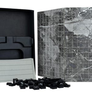 May include: A Quinto board game set featuring a black storage box with a moulded plastic insert, a folding game board with a grey and white marble pattern grid, a pad of score sheets, and a collection of small black square tiles with white numbers.