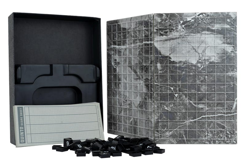 May include: A Quinto board game set featuring a black storage box with a moulded plastic insert, a folding game board with a grey and white marble pattern grid, a pad of score sheets, and a collection of small black square tiles with white numbers.
