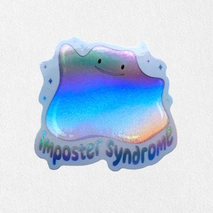 May include: A holographic sticker featuring a blue and purple cartoon character with a smile. The character is shaped like a blob and has the text "Imposter Syndrome" written below it.