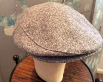 May include: A gray wool newsboy cap with a slightly curved brim.