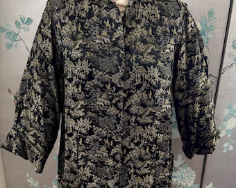 May include: A black and gold brocade robe with a traditional Chinese design. The robe has a mandarin collar and a button closure.