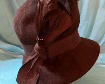 1920 vintage, brown felt, cloche hat with brown, iridescent feathers wrapped with a rhinestone ring