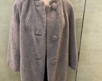 May include: A gray fuzzy coat with a mandarin collar and four large buttons.